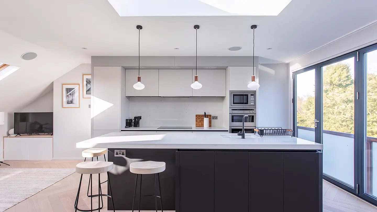 Finished kitchen with black island and pendant lights